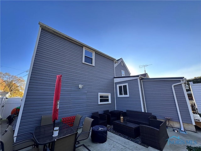 rear view of house featuring a patio area and outdoor lounge area