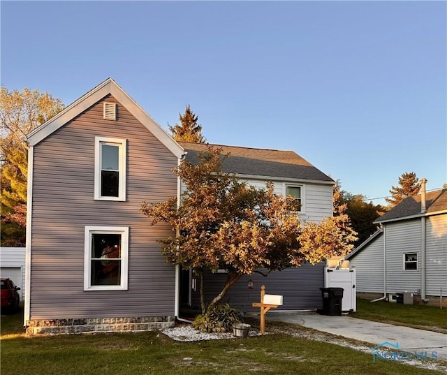 rear view of property with a yard