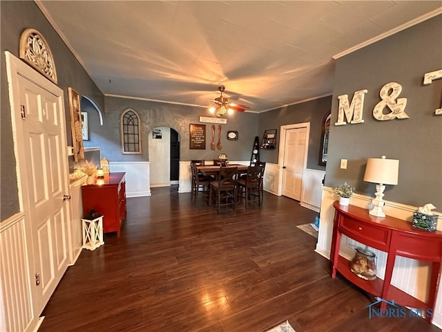 dining space with crown molding, dark hardwood / wood-style floors, and ceiling fan