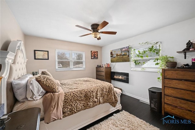 bedroom with ceiling fan and dark hardwood / wood-style floors