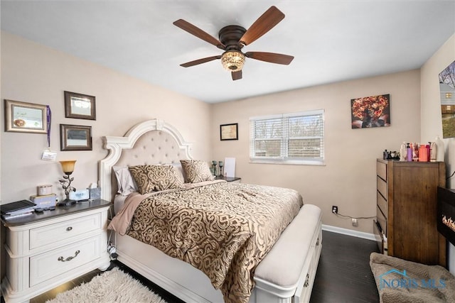 bedroom featuring dark hardwood / wood-style floors and ceiling fan