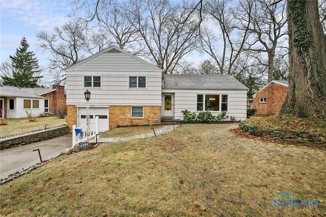 view of front of house featuring a garage and a front lawn