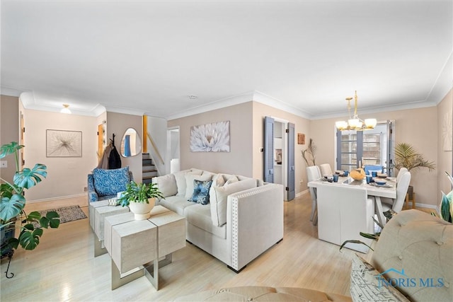 living room featuring ornamental molding, light wood-type flooring, and a chandelier