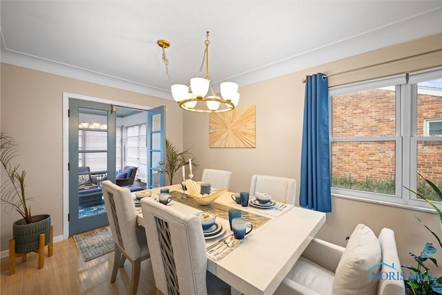 dining space featuring a notable chandelier and hardwood / wood-style floors