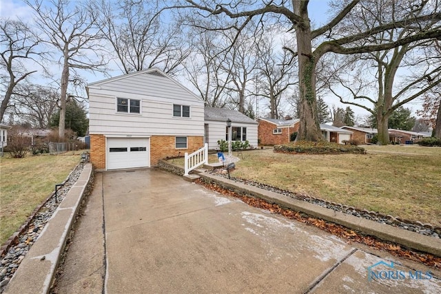 tri-level home featuring a garage and a front lawn