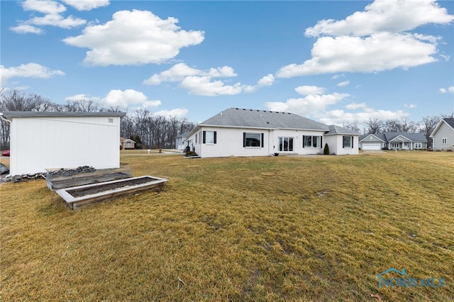 rear view of house with a lawn