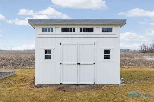 view of outdoor structure with a lawn