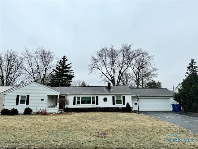 single story home featuring a garage and a front yard