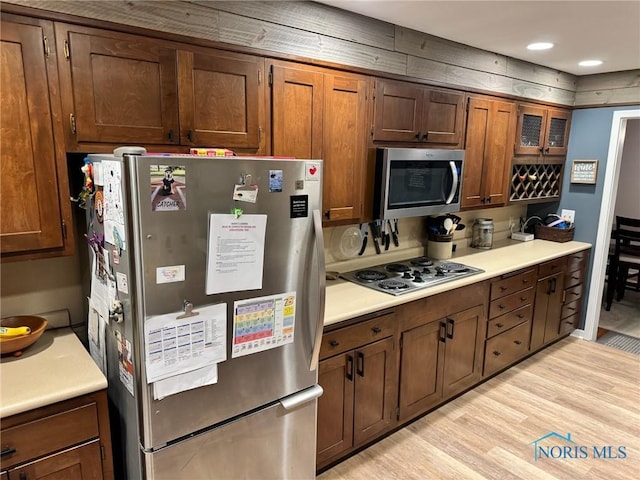 kitchen featuring appliances with stainless steel finishes and light hardwood / wood-style floors