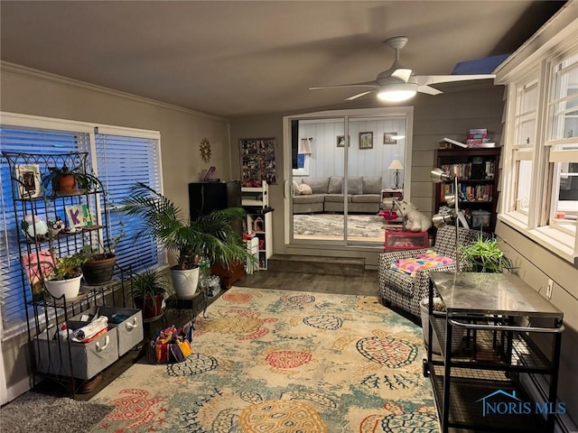 living room with ornamental molding, hardwood / wood-style floors, and ceiling fan