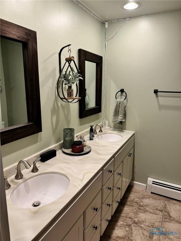 bathroom featuring vanity and baseboard heating