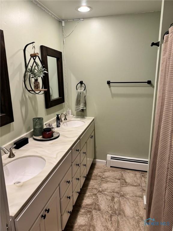 bathroom with vanity and a baseboard heating unit