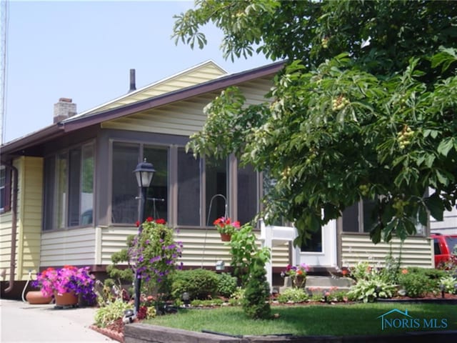 bungalow-style house with a sunroom