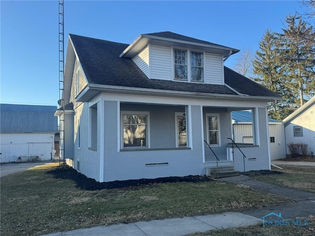 view of front of home with a porch and a front lawn