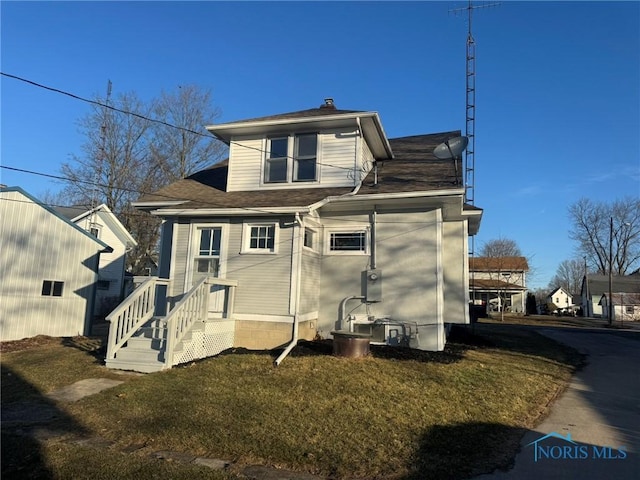 back of house with a yard