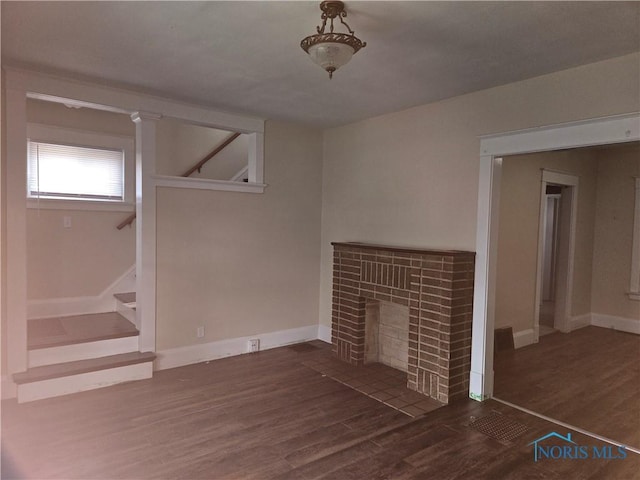 unfurnished living room featuring dark hardwood / wood-style flooring