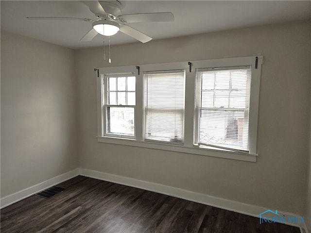 unfurnished room with dark wood-type flooring and ceiling fan