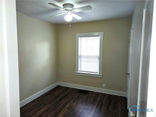 empty room featuring dark hardwood / wood-style floors and ceiling fan