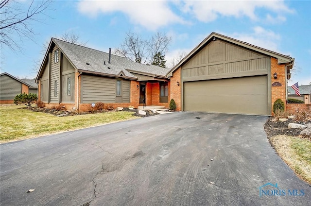 single story home with a garage and a front lawn