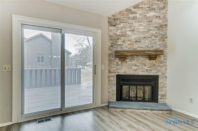 32 Abbey Rd, Perrysburg, OH 43551 - entryway with visible vents, baseboards, a fireplace, wood finished floors, and vaulted ceiling