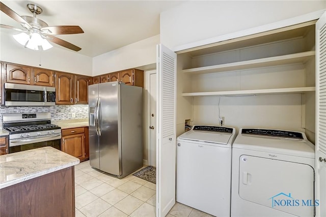 32 Abbey Rd, Perrysburg, OH 43551 - kitchen featuring tasteful backsplash, open shelves, ceiling fan, washer and dryer, and appliances with stainless steel finishes