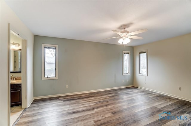 interior space featuring ceiling fan, sink, and light hardwood / wood-style floors