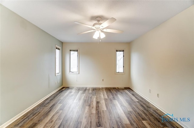 unfurnished room featuring ceiling fan and dark hardwood / wood-style floors