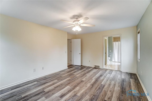 empty room with light hardwood / wood-style flooring and ceiling fan