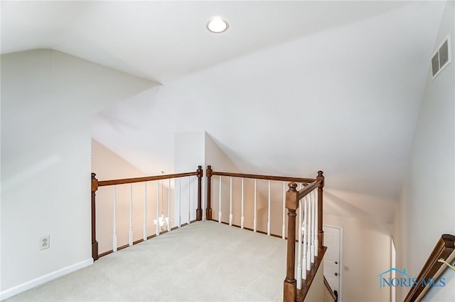 additional living space featuring vaulted ceiling and carpet