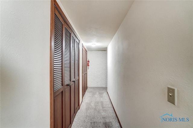 hall featuring light colored carpet