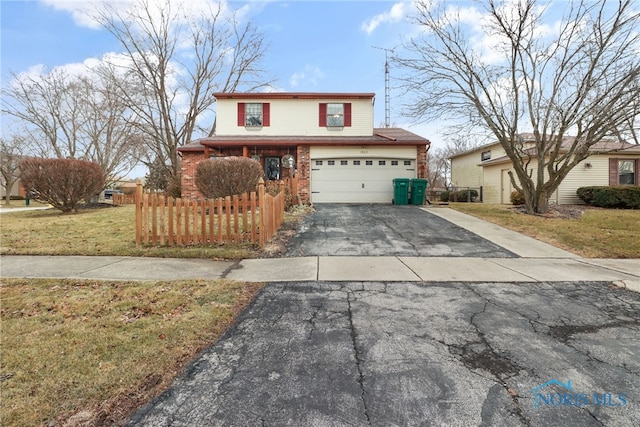 front of property featuring a garage and a front yard