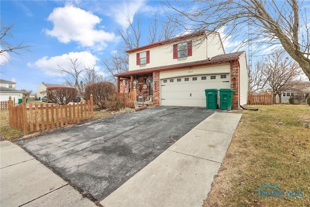 front facade with a garage, a front yard, and covered porch