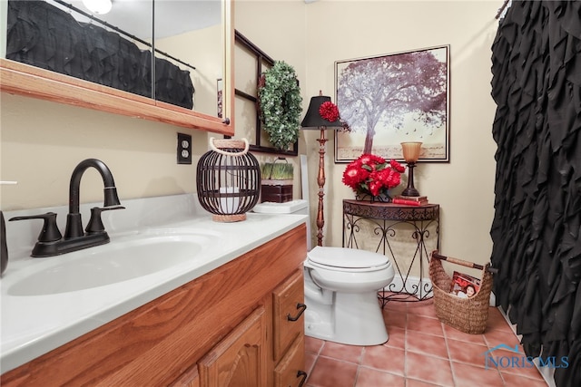 bathroom with tile patterned floors, toilet, and vanity