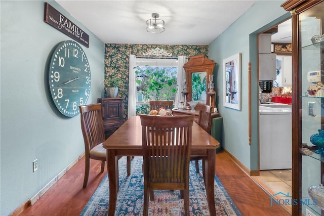 dining room with hardwood / wood-style flooring and washer / dryer