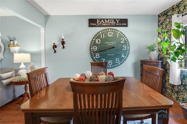 dining space with wood-type flooring