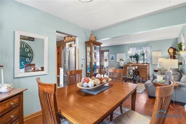 dining space with wood-type flooring