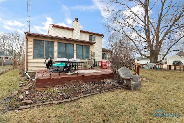 back of house with a yard and a deck