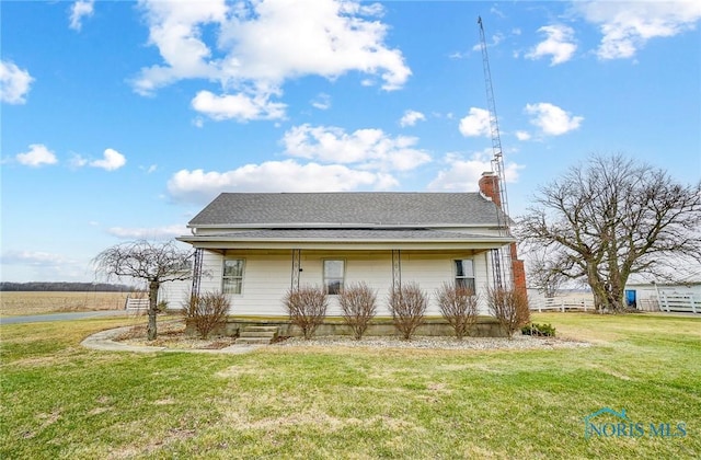 back of house with a yard