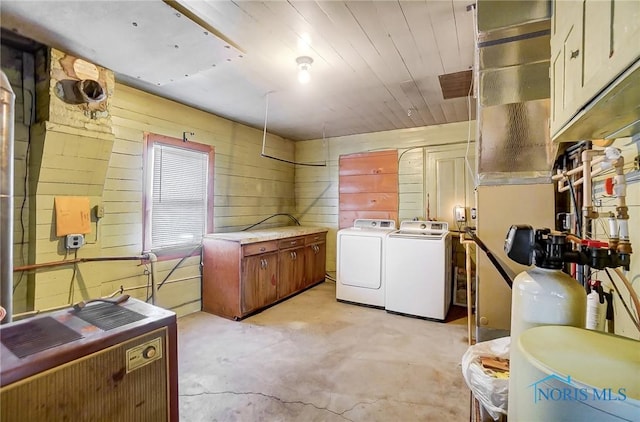 washroom featuring wooden walls, washer and clothes dryer, heating unit, and wooden ceiling