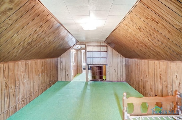 additional living space with lofted ceiling, wood ceiling, carpet, and wood walls