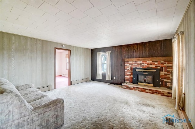 living room featuring carpet, wood walls, and baseboard heating