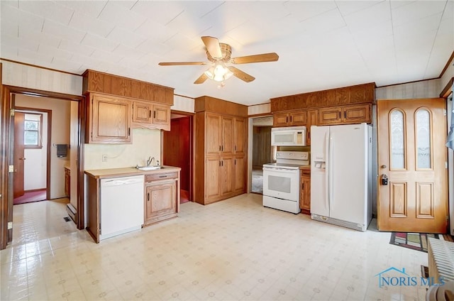 kitchen with ceiling fan, white appliances, crown molding, and sink