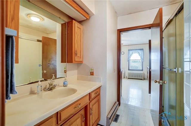 bathroom with baseboard heating, vanity, and radiator