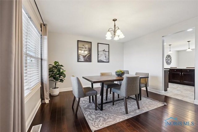 dining room with an inviting chandelier and light wood-type flooring