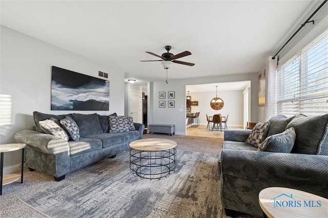 living room with carpet floors and ceiling fan