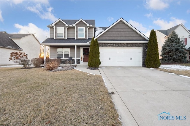 view of front of home with a porch, a garage, and a front yard