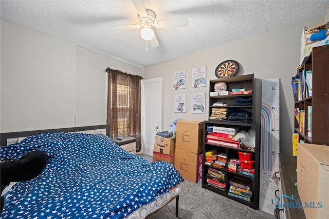 carpeted bedroom featuring ceiling fan and a textured ceiling