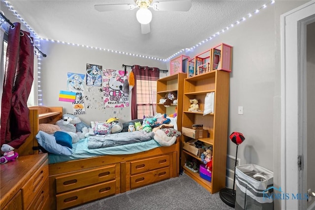 bedroom featuring ceiling fan, carpet flooring, and a textured ceiling