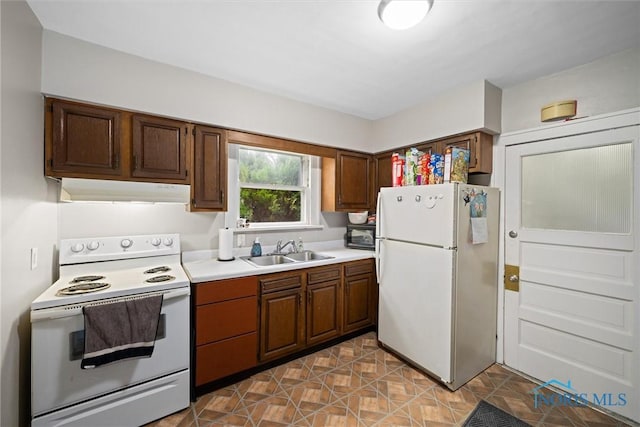 kitchen featuring white appliances and sink