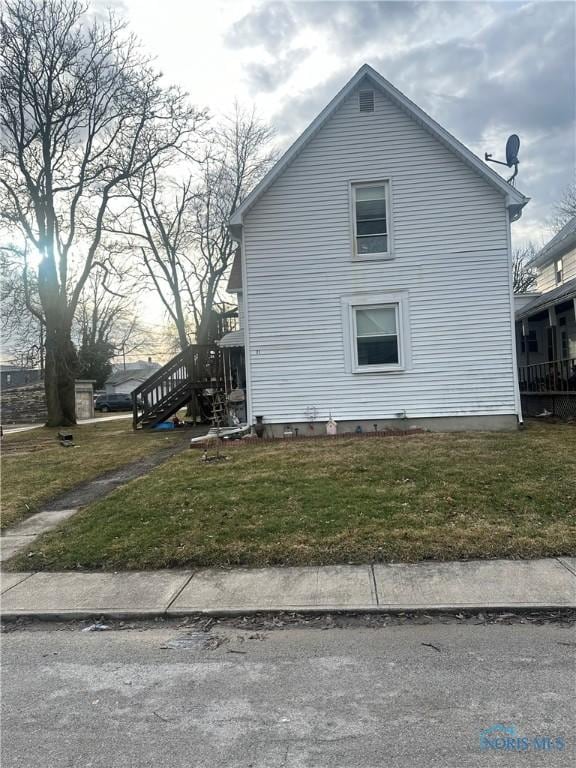 view of home's exterior featuring a yard